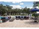Community pool area featuring comfortable sofas, umbrellas, and tables with chairs at 13118 Rain Lily Dr, Riverview, FL 33579