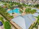 Aerial view of community pool, amenity center and playground surrounded by well-maintained landscaping and neighborhood homes at 13118 Rain Lily Dr, Riverview, FL 33579