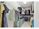 Organized walk-in closet with shelving, hanging rods, and storage drawers for optimal storage solutions at 13118 Rain Lily Dr, Riverview, FL 33579