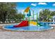 Vibrant water park with colorful slides and interactive features, adding fun to the community pool at 13118 Rain Lily Dr, Riverview, FL 33579