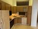 The kitchen features wood cabinets, essential appliances, and a functional layout ready for culinary creations at 1371 Pine Ridge E Cir # B8, Tarpon Springs, FL 34688
