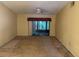 An open living room with sliding glass door provides seamless access to outdoor views and ample natural light at 1371 Pine Ridge E Cir # B8, Tarpon Springs, FL 34688