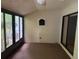 This sunroom has multiple windows and a ceiling fan, offering a relaxing spot with outdoor views at 1371 Pine Ridge E Cir # B8, Tarpon Springs, FL 34688