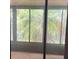 A sliding glass door with an outdoor view of palms at 1371 Pine Ridge E Cir # B8, Tarpon Springs, FL 34688