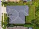 A high-angle shot showcasing a home with a neatly manicured lawn and a well-maintained roof at 15135 Azra Dr, Odessa, FL 33556