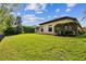 Lush backyard with a well manicured lawn and mature trees offering plenty of privacy at 15135 Azra Dr, Odessa, FL 33556