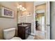 Bathroom with a dark wood vanity with granite countertop, decorative lights, and tile flooring at 15135 Azra Dr, Odessa, FL 33556