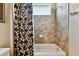 Bathroom featuring a tiled shower with a brown-patterned shower curtain at 15135 Azra Dr, Odessa, FL 33556