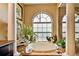 Luxurious bathroom with an elegant tub and arched window providing natural light at 15135 Azra Dr, Odessa, FL 33556