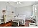 Cozy bedroom with hardwood floors, soft lighting, and a comfortable queen bed at 15135 Azra Dr, Odessa, FL 33556