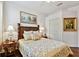 Bedroom with a decorative headboard, wood floors, and neutral colored walls at 15135 Azra Dr, Odessa, FL 33556
