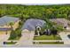 Beautiful home with a three car garage, well manicured landscaping, and mature trees at 15135 Azra Dr, Odessa, FL 33556