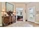 Beautiful foyer with tile flooring, wooden console table, and decorative glass door leading to home office at 15135 Azra Dr, Odessa, FL 33556