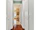 Hallway showcasing the bathroom with tub and vanity, accessible through an open door at 15135 Azra Dr, Odessa, FL 33556
