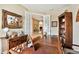 Spacious home office with rich wood floors, a large custom desk, and French doors leading to the foyer at 15135 Azra Dr, Odessa, FL 33556