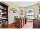 Cozy home office features rich wood floors, custom built-ins, and a large window providing natural light at 15135 Azra Dr, Odessa, FL 33556