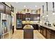 Gourmet kitchen boasts stainless steel appliances, a center island, and ample cabinet space at 15135 Azra Dr, Odessa, FL 33556