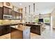 Gourmet kitchen features stainless steel appliances, island and opens to the living room at 15135 Azra Dr, Odessa, FL 33556
