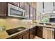 Close up of kitchen featuring stainless steel appliances and tile backsplash at 15135 Azra Dr, Odessa, FL 33556