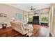 Bright living room featuring hardwood floors, neutral paint, and a comfortable reclining sofa at 15135 Azra Dr, Odessa, FL 33556