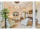 Elegant living room with tile floors, a decorative ceiling, and classic furnishings providing a comfortable ambiance at 15135 Azra Dr, Odessa, FL 33556