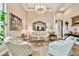 Bright living room with stylish decor, neutral colors, tile flooring, and large windows creating a welcoming space at 15135 Azra Dr, Odessa, FL 33556