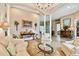 Open living room with tile floors, large support columns, and stylish sofa provides an elegant entertaining area at 15135 Azra Dr, Odessa, FL 33556