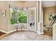 Sunlit living space featuring a large window with views of the lush backyard at 15135 Azra Dr, Odessa, FL 33556