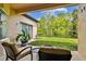 Spacious covered patio with comfortable seating and a serene backyard view at 15135 Azra Dr, Odessa, FL 33556