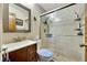 Cozy bathroom featuring a shower with glass enclosure and a vanity with a framed mirror at 1524 Essex N Dr, St Petersburg, FL 33710
