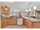 Well-appointed kitchen with wooden cabinets, granite countertops, and an open layout to the dining area at 1524 Essex N Dr, St Petersburg, FL 33710