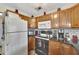 Functional kitchen equipped with modern appliances, wood cabinets, and ample counter space at 1524 Essex N Dr, St Petersburg, FL 33710