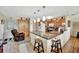 Bright kitchen featuring granite countertops, wooden cabinetry, and a convenient breakfast bar area at 1524 Essex N Dr, St Petersburg, FL 33710