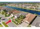 Aerial view of the home in a lakeside community with lush landscaping and well-maintained streets at 15528 Corona Del Mar Dr, Wimauma, FL 33598