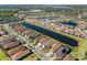 Aerial view of a lakefront community with lush landscaping and beautiful homes at 15528 Corona Del Mar Dr, Wimauma, FL 33598