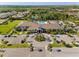 Beautiful aerial view of the Valencia Del Sol clubhouse, pool, parking and luxurious green surroundings at 15528 Corona Del Mar Dr, Wimauma, FL 33598