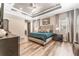 Bright main bedroom features a tray ceiling, wood floors, and ensuite bathroom at 15528 Corona Del Mar Dr, Wimauma, FL 33598