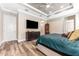 Spacious main bedroom featuring wood floors, tray ceiling, and television at 15528 Corona Del Mar Dr, Wimauma, FL 33598