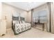 Guest bedroom featuring a twin bed, tile floors, and soft decor at 15528 Corona Del Mar Dr, Wimauma, FL 33598