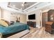 Bright main bedroom featuring an entertainment center and wood-look floors at 15528 Corona Del Mar Dr, Wimauma, FL 33598