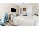 Bright bedroom with a queen bed, TV, modern decor and hardwood flooring at 15528 Corona Del Mar Dr, Wimauma, FL 33598