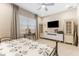 Bright bedroom featuring soft decor, tile floors, and a television at 15528 Corona Del Mar Dr, Wimauma, FL 33598