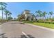 Community entrance with lush tropical landscaping, trees and manicured lawn at 15528 Corona Del Mar Dr, Wimauma, FL 33598