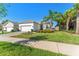Attractive single-Gathering home with a lush green lawn, brick driveway, and vibrant flowerbeds, enhancing its curb appeal at 15528 Corona Del Mar Dr, Wimauma, FL 33598