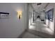 Hallway with tile flooring, lighting fixtures, and an 'Arts & Crafts' sign displayed at 15528 Corona Del Mar Dr, Wimauma, FL 33598