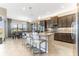 Modern kitchen featuring granite countertops, stainless steel appliances, and a breakfast bar with seating at 15528 Corona Del Mar Dr, Wimauma, FL 33598