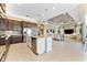 Open kitchen and living room featuring stainless steel appliances, central island, and tile flooring at 15528 Corona Del Mar Dr, Wimauma, FL 33598