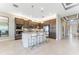 Kitchen with large island and breakfast bar featuring stainless steel appliances and tile backsplash at 15528 Corona Del Mar Dr, Wimauma, FL 33598