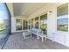 Outdoor lanai with patio seating, screened-in enclosure, and sliding glass doors at 15528 Corona Del Mar Dr, Wimauma, FL 33598