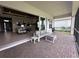 View of living room through the sliding glass doors with the screened-in patio and outdoor seating at 15528 Corona Del Mar Dr, Wimauma, FL 33598
